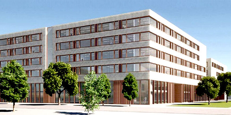 Moderne Gebäude mit großen Fenstern, umgeben von Bäumen, im klaren Himmel. Ideal für Büro- oder Wohnnutzung.